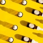 clear glass bottles on yellow plastic container