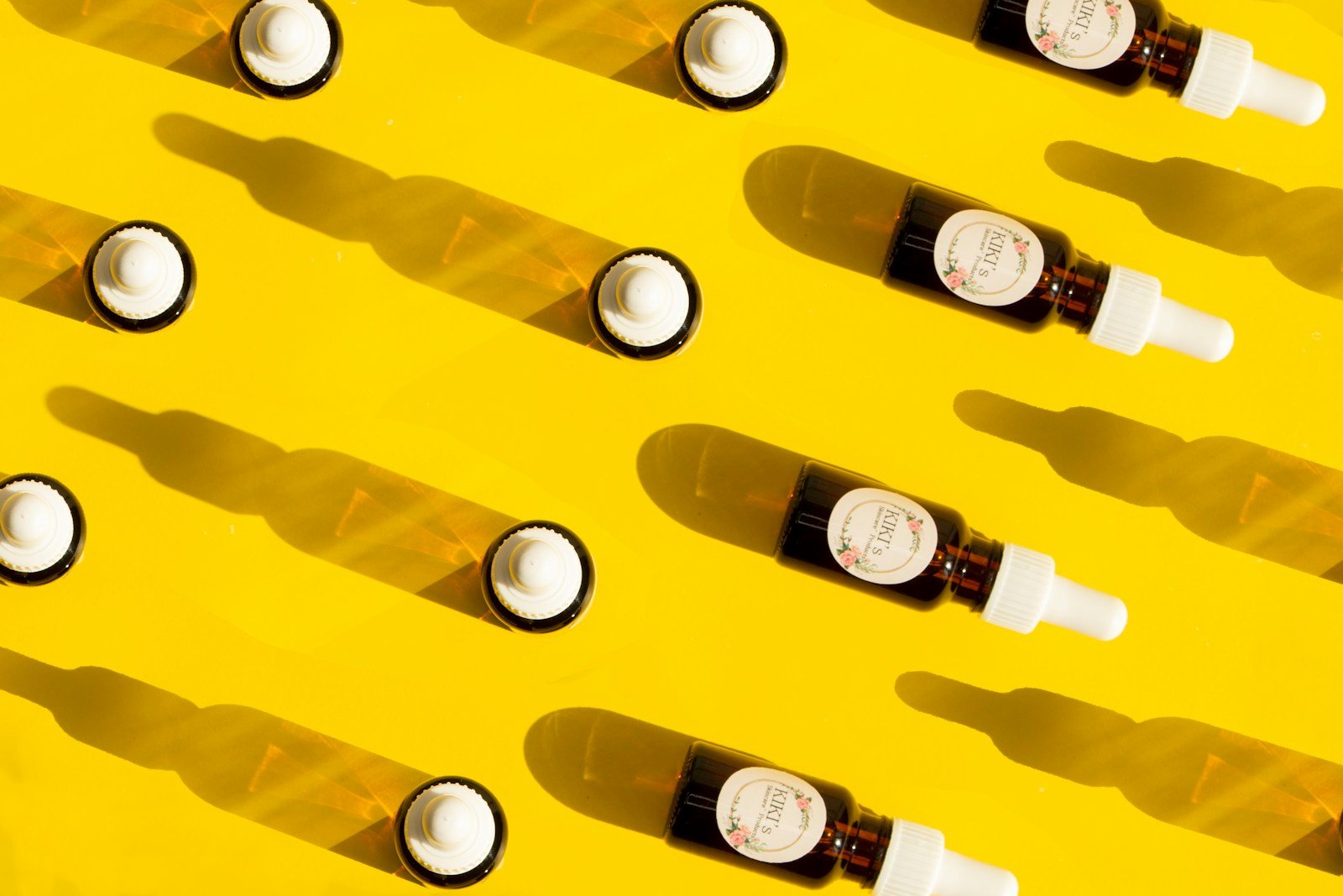 clear glass bottles on yellow plastic container